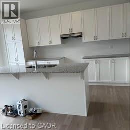 A kitchen with white cabinets and a countertop.