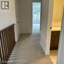 A hallway with a Realty logo on the wall.