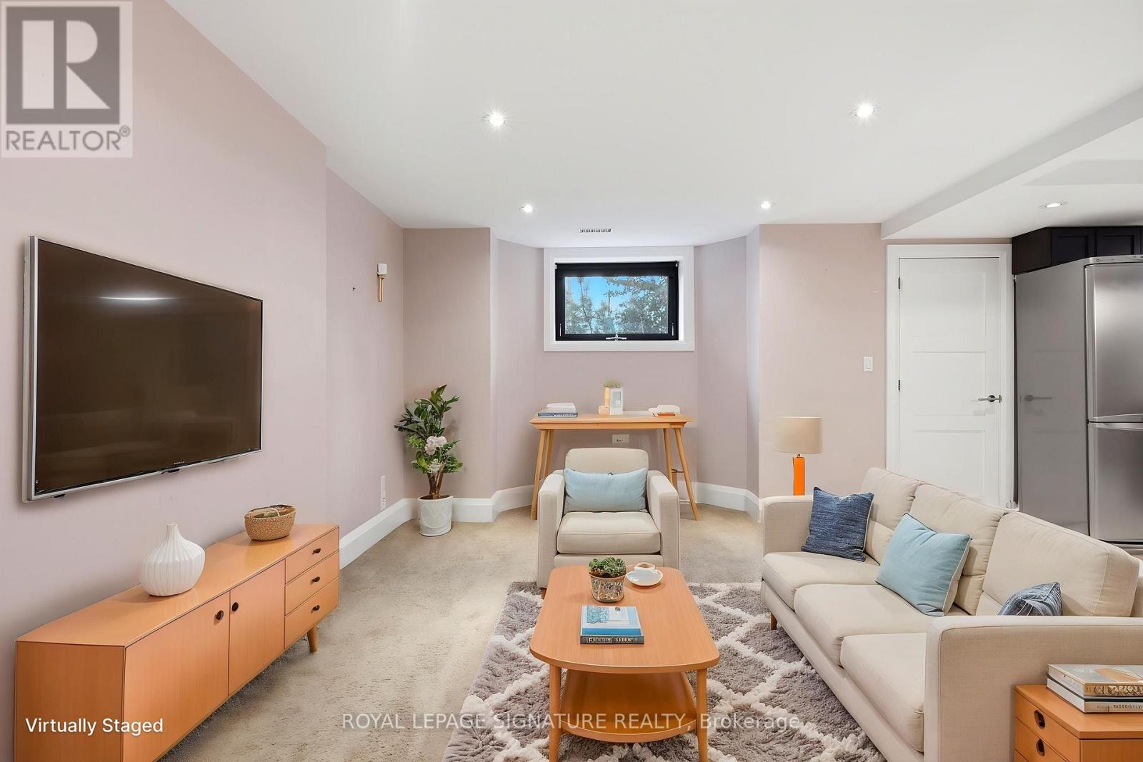 A living room with a television, a couch, and a coffee table.