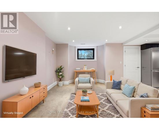 A living room with a television, a couch, and a coffee table.