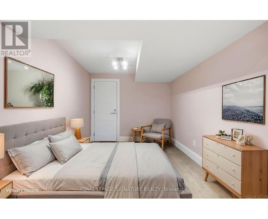 A bedroom with a bed, nightstand, and chair.