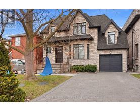 A large house with a driveway in front of it.
