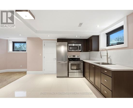 A modern kitchen with a stainless steel oven and microwave.