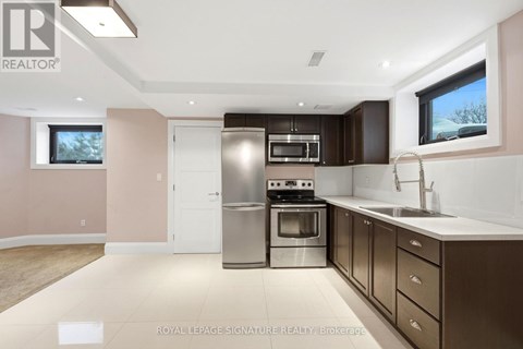 A modern kitchen with a stainless steel oven and microwave.