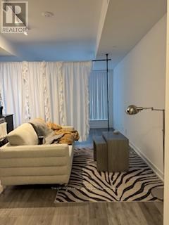 A living room with a zebra print rug and a white couch.