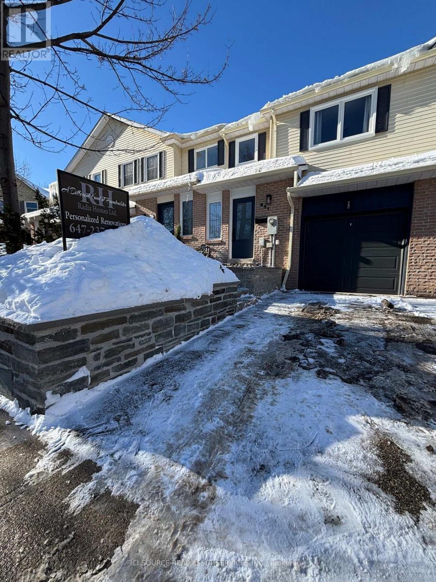 A snow-covered driveway leads to a residential building with a sign that reads "Renaissance.".