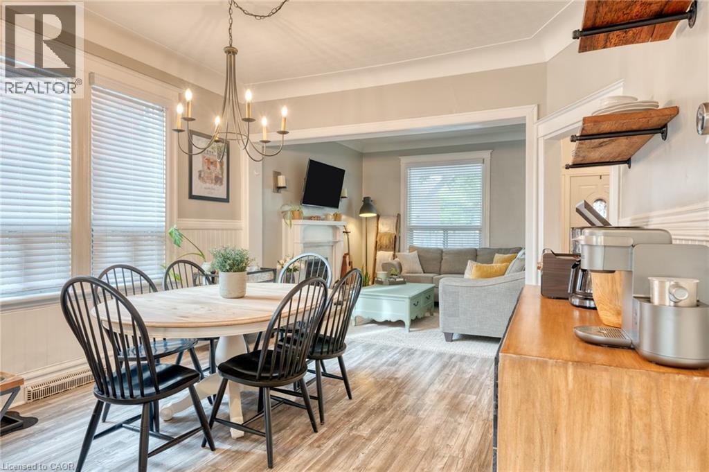 A dining room with a table set for four.