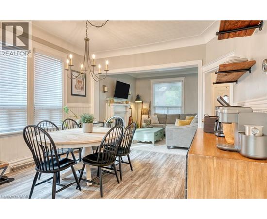 A dining room with a table set for four.
