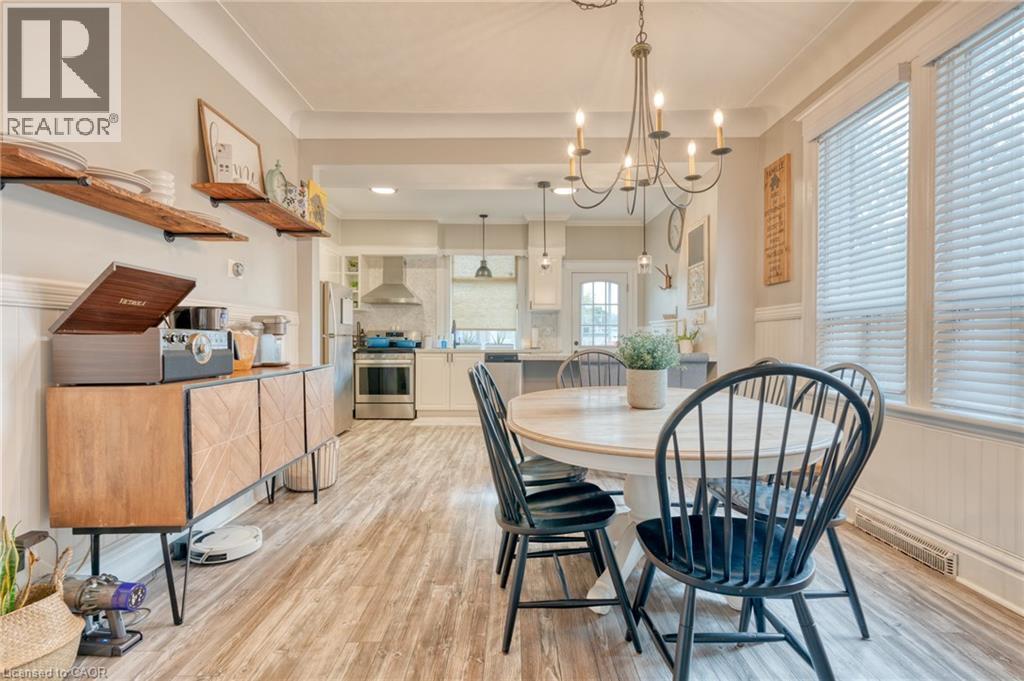 A modern kitchen with a wooden floor and a dining table set with chairs.