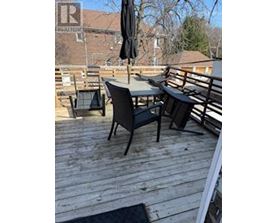 A wooden deck with a table and chairs.
