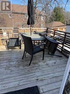 A wooden deck with a table and chairs.
