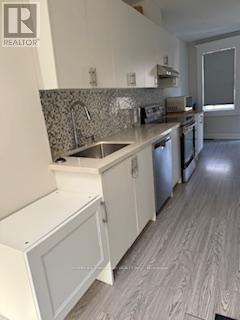 A kitchen with a sink and a dishwasher.