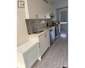A kitchen with a sink and a dishwasher.