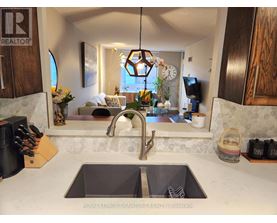 A kitchen with a sink and a window.