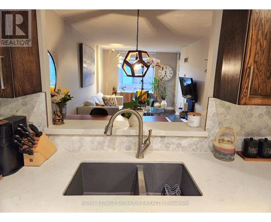 A kitchen with a sink and a window.