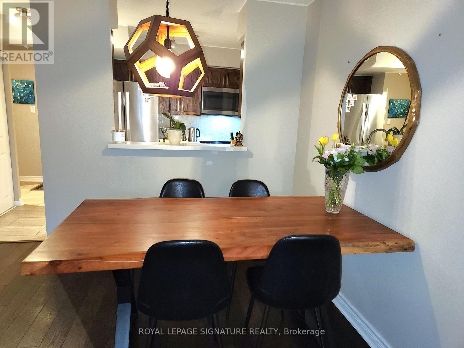 A dining room with a wooden table and chairs.