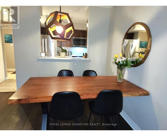 A dining room with a wooden table and chairs.