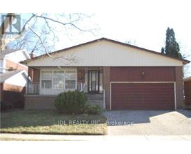 A house with a red garage door is for sale in Brokerage.