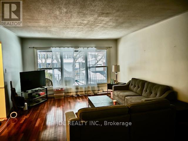 A living room with a grey couch and a television.