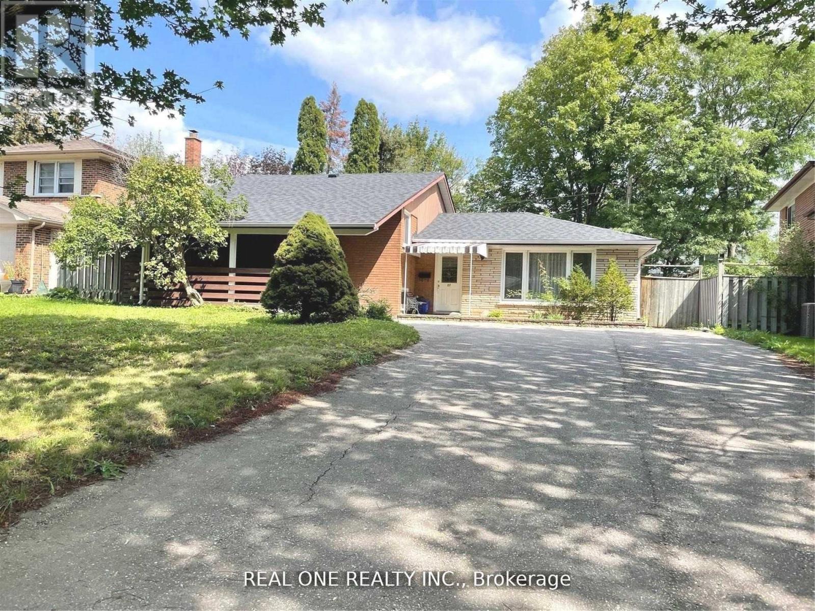 A house with a driveway in front of it is for sale with REAL ONE REALTY INC.