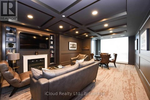 A modern living room with a grey sofa and a fireplace.