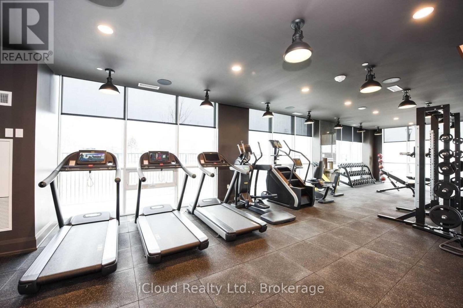 A gym with treadmills, weights, and exercise equipment.