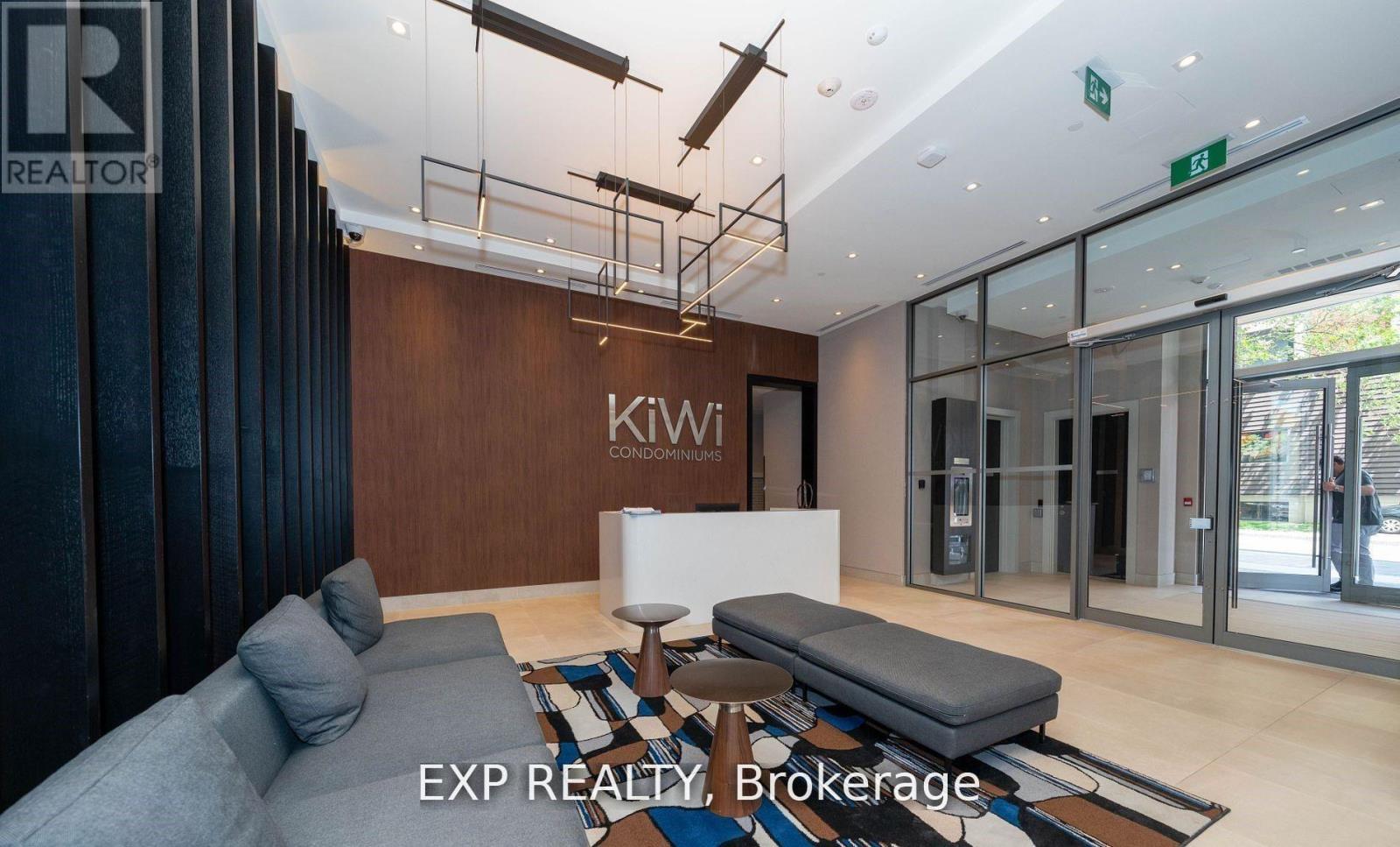 A modern waiting area with a bench, a couch, and a coffee table.