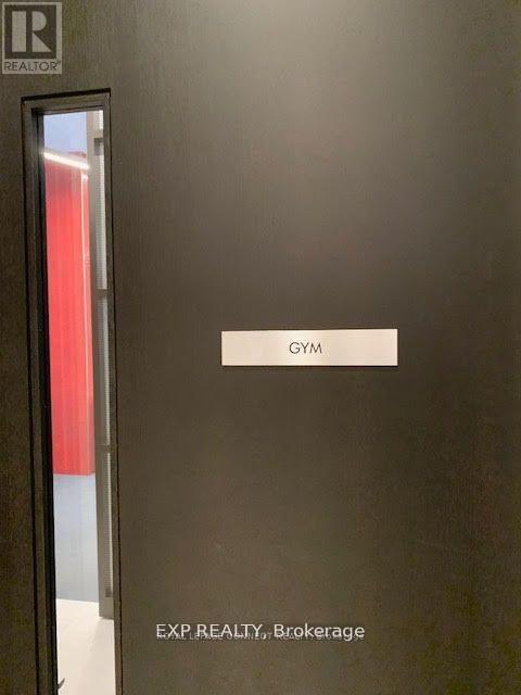 A black door with a sign that says Gym.