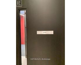 A black door with a sign that says Gym.
