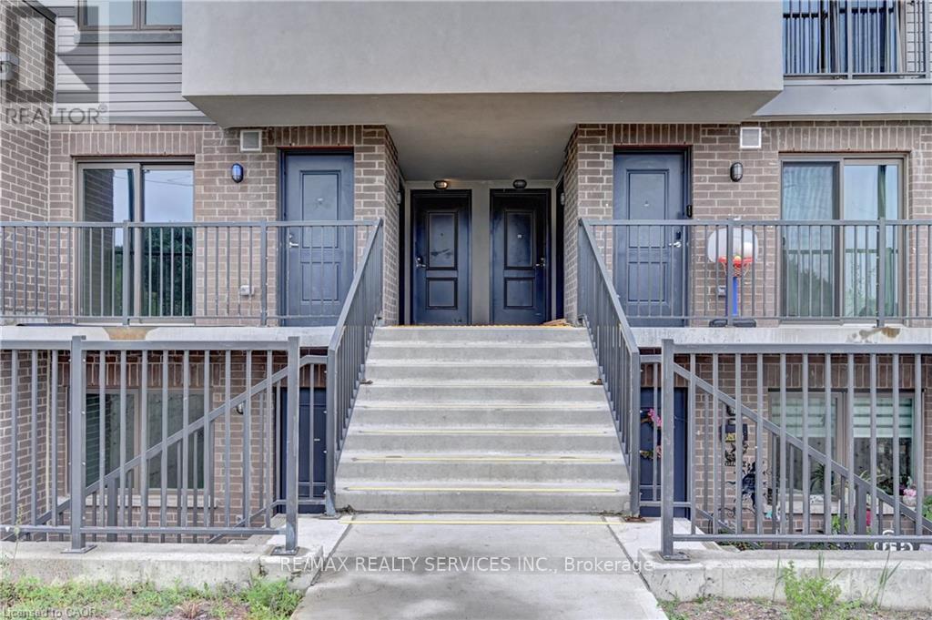 The front of a building with a sign that says "REALTOR" on the top left corner.