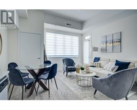A modern dining room with a glass table and chairs.