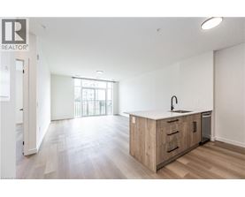 A spacious kitchen with wooden cabinets and a large window.