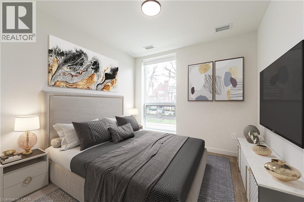 A bedroom with a large bed and a painting on the wall.