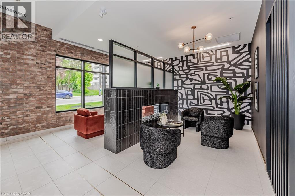 A modern living room with a brick wall and a black and white patterned wallpaper.
