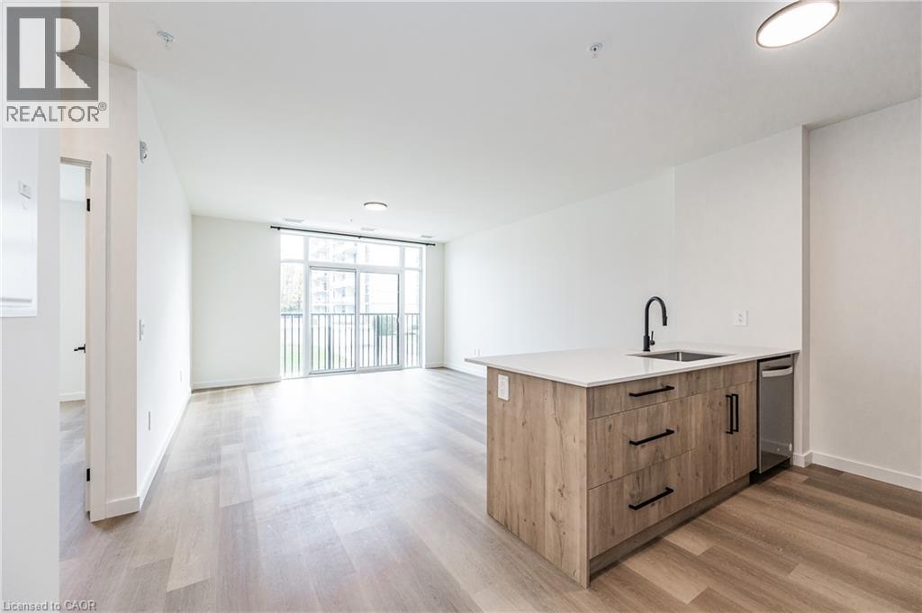 A spacious kitchen with wooden cabinets and a large window.