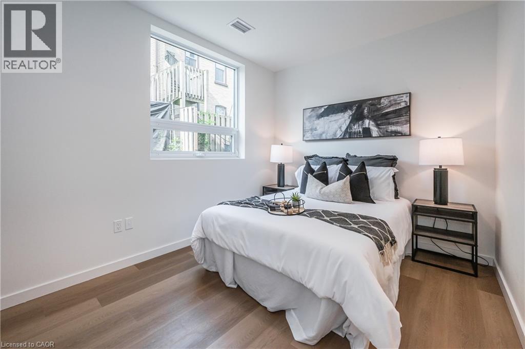 A bedroom with a large bed and a window overlooking a building.