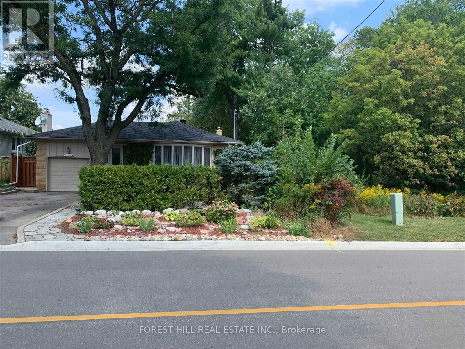 A house with a landscaped front yard is for sale with Forest Hill Real Estate Inc. in Brokerage.
