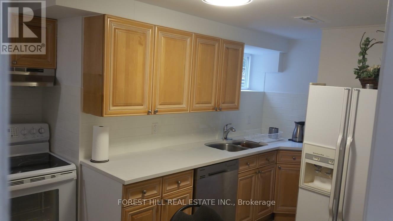 A kitchen with wooden cabinets and white appliances.