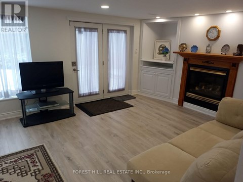 A living room with a black television set on a stand.
