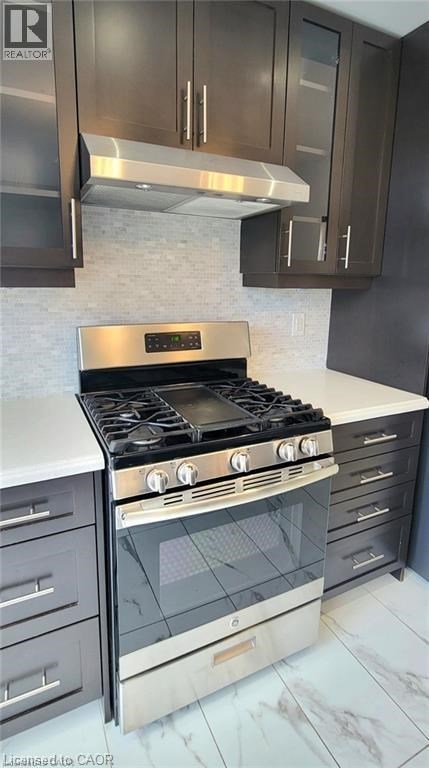 A modern kitchen with a stove and oven.