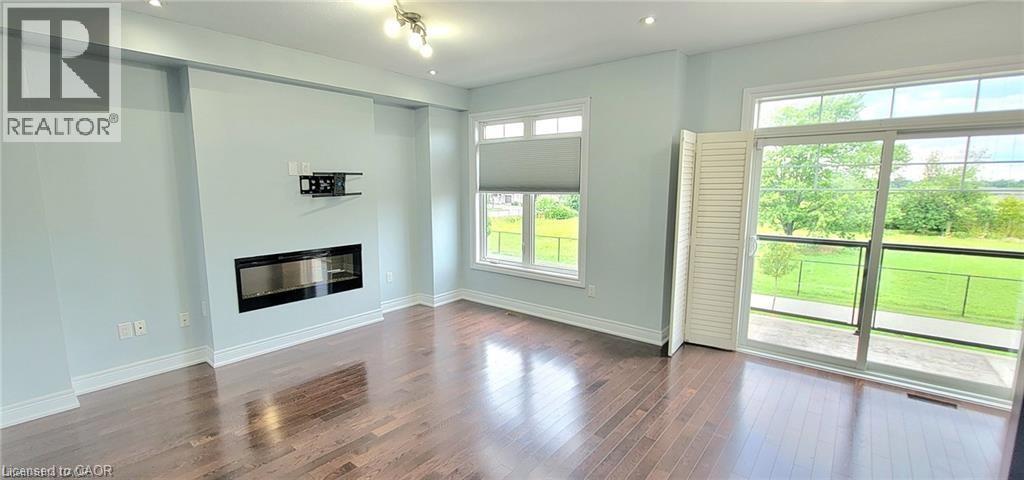 A spacious living room with a fireplace and sliding glass doors.