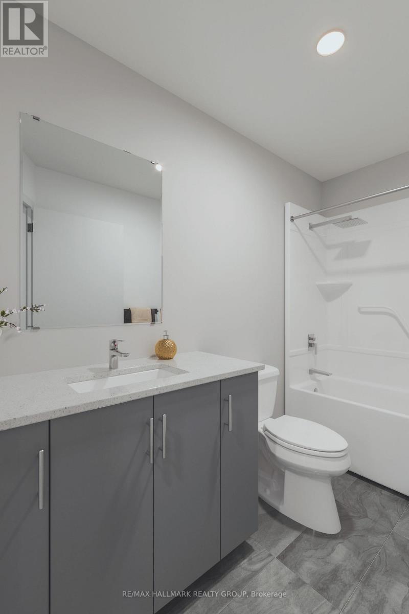 A bathroom with a white toilet, sink, and bathtub.