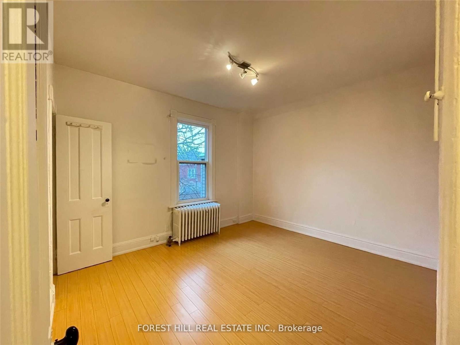 A room with a window and a radiator.