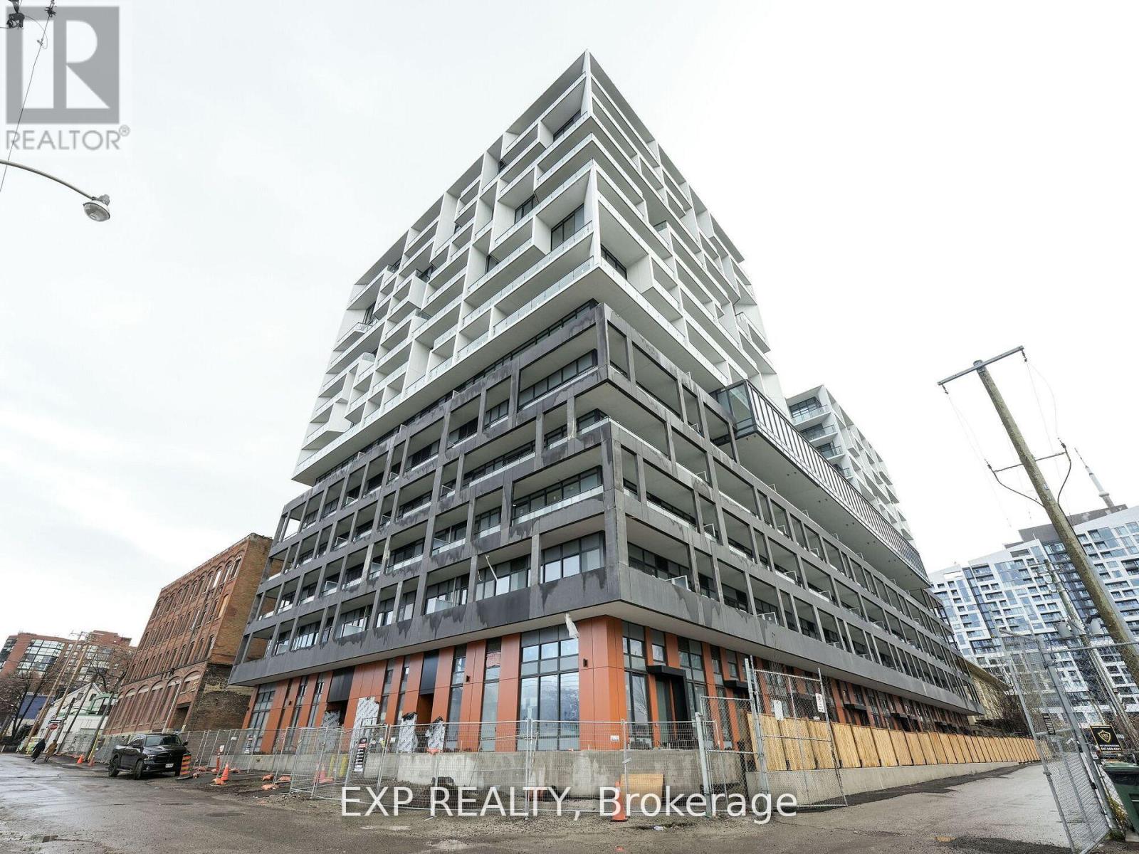 A tall building under construction with the words EXP REALTY, Brokerage written on it.