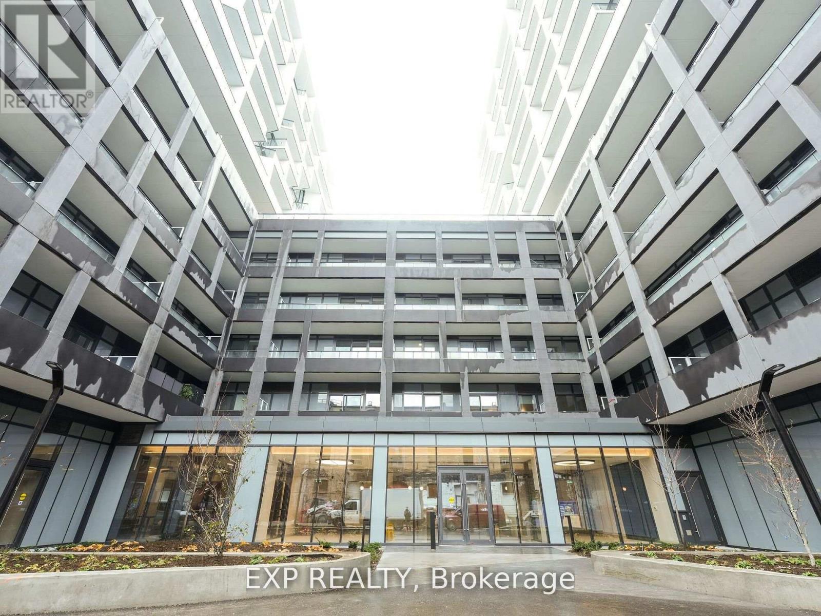 A modern building with the words EXP REALTY, Brokerage on the bottom.