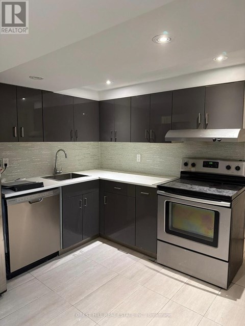 A modern kitchen with a stainless steel dishwasher and oven.