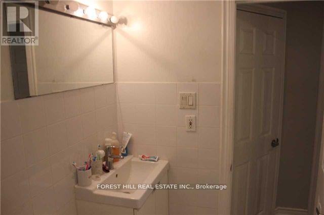 A bathroom with a white sink and a mirror above it.
