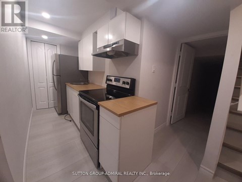 A kitchen with a stove top oven and a microwave.