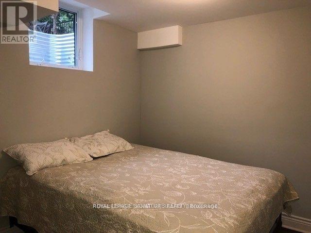 A bedroom with a bed and a window.
