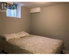 A bedroom with a bed and a window.